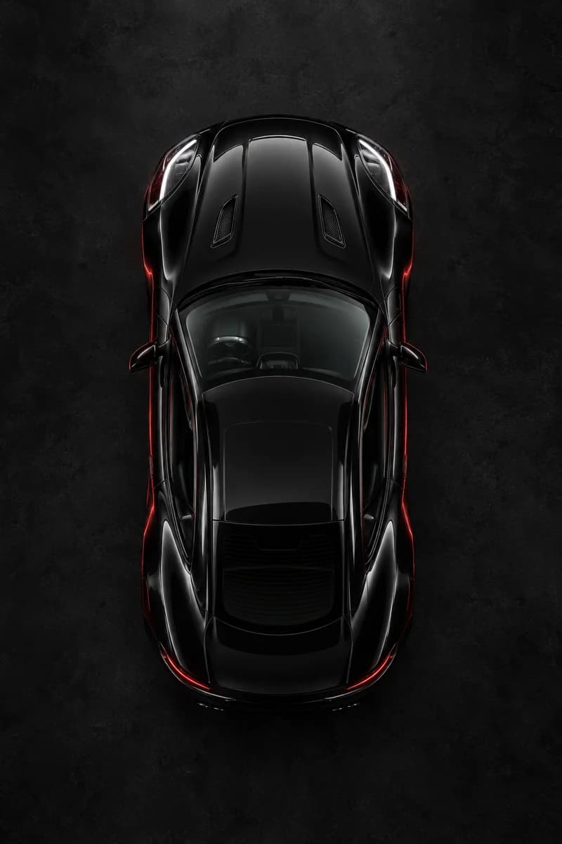 Illustrative overhead view of a black sports coupe with red rim lighting